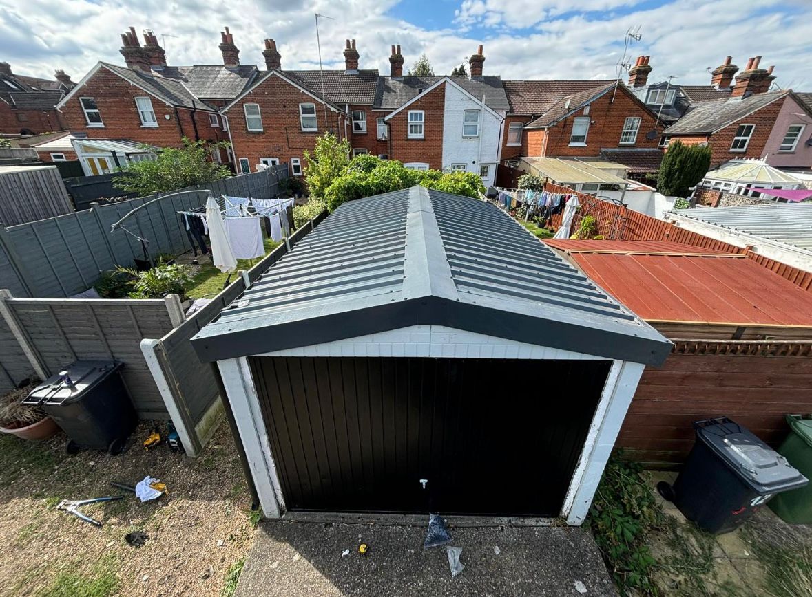 Old asbestos cement roof on a garden shed before removal
